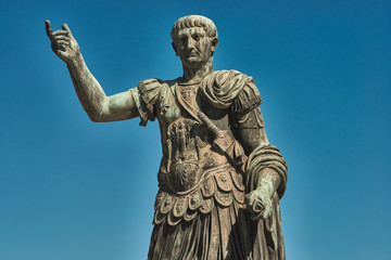 Rome, Bronze statue of emperor Caesar Nervae Trajan, Forum of Caesar Nervae Trajan in the background