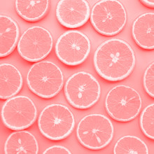 Group Of Orange Slice In Pink Color.fruit And Summer Concept