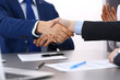 © rogerphoto - Business people shaking hands, finishing up a papers signing. Meeting, contract and lawyer consulting concept