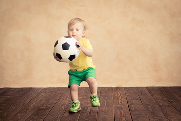 Wall Mural - Child is pretending to be a soccer player