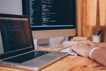 Close up hand of developing programming and coding technologies. Programmer hand typing on keyboard. Put on the wood table. Programmer concepts.