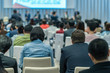 © THANANIT - Speakers on the stage with Rear view of Audience in the conference hall or seminar meeting, business and education about investment concept