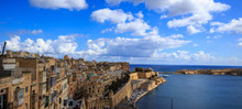 Malta, Valletta. Grand Harbor In Mediterranean. Blue Sea And Blue Sky With Few Clouds Background. Panoramic View, Banner.