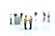 © keatikun - Miniature people : Businessman Leads Meeting Conference Discussion Corporate Concept.