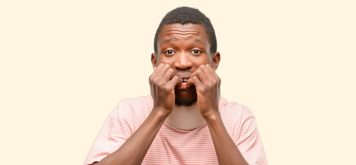 Wall Mural - Injured african black man wearing neck brace terrified and nervous expressing anxiety and panic gesture, overwhelmed