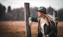 Beautiful Stylish Woman In Hat On Rural Country Farm