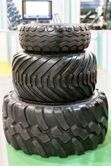 Wall Mural - Three tractor tyre covers separately. Big truck or tractor wheel a black tires closeup