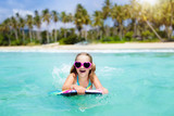 Fototapeta  - Kids surf on tropical beach. Vacation with child.