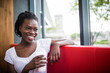 © F8  \ Suport Ukraine - Young afro american woman drink milkshake in cafe