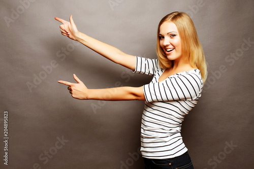 Happy smiling beautiful young woman showing copyspace, visual imaginary or somet Poster