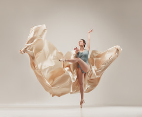 Wall Mural - Modern ballet dancer dancing in full body on white studio background.