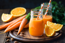 Healthy Detox Orange Carrot Smoothie Or Juice In Glass Jars On Wooden Background With Fresh Ingredients
