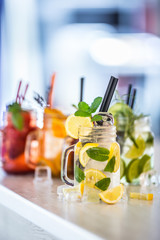 Wall Mural - Various lemonades in mason jars with orange lime lemon otange strawberries and fresh fruit fruits