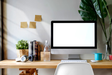 Mock up workspace wooden table with Blank screen computer, dummy, houseplant. desk workspace with isolate  screen for graphic display montage.