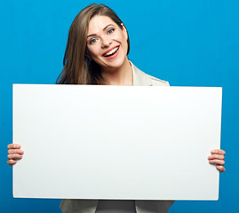 Smiling woman holding white billboard for advertising sign.