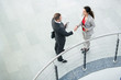 © Seventyfour - High angle portrait of successful businesswoman shaking hands with partner in modern office building after closing beneficial deal, copy space
