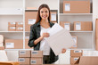 © Africa Studio - Young woman preparing parcel envelope for shipment to client in home office