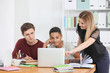 © Africa Studio - Group of teenagers doing homework with teacher in classroom