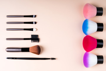 Wall Mural - Cosmetics accessories for makeup on beige background flat lay. Set of cosmetics brushes. Minimal composition. Fashion and beauty blogging concept. Top view, copy space