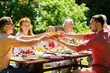 © Syda Productions - leisure, holidays and people concept - happy family having festive dinner or summer garden party
