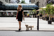 © Alexander - happy woman with dog shopping in the city in summer