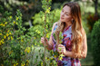 © Volodymyr Shcherbak - Portrait beautiful happy woman enjoying smell in a flowering spring blooming garden. Bright and fashionable smiling girl near blossom cherry tree