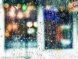 Wall Mural - water drops on window glass in the city