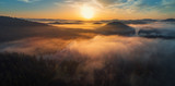Fototapeta Natura - Aerial view of morning fog on the lake, sunrise shot