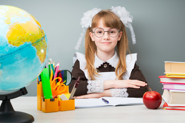 Female child sitting in school pose and looking at camera