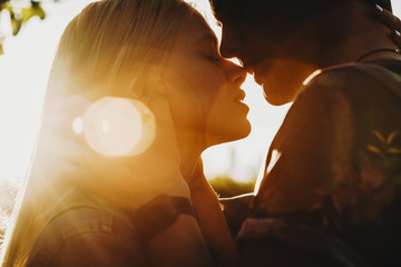 close up portrait of a beautiful young couple waiting to kiss in their traveling time against sunset