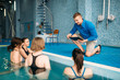 © Nomad_Soul - Female fitness class with trainer, aqua aerobics