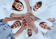 © ASDF - bottom view.a team of doctors at the medical center clasped their hands together