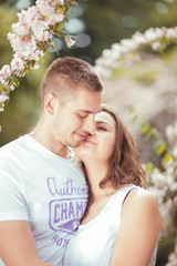 Young couple having fun in a sunny park in springtime, beautiful, romantic mood