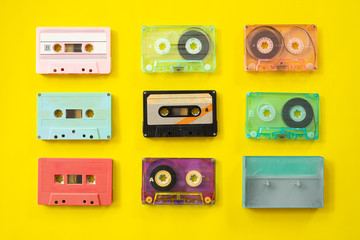 set of vintage tape cassette recorder on yellow background, flat lay, top view. retro technology