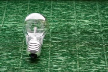 Light bulb on green background. Minimal concept. Copy space