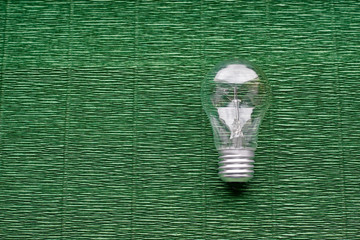 Light bulb on green background. Minimal concept. Copy space