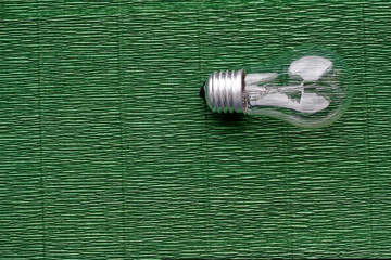 Light bulb on green background. Minimal concept. Copy space