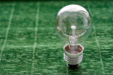 Light bulb on green background. Minimal concept. Copy space