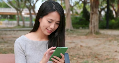 Poster - Woman working on smart phone in the park