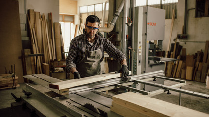 Carpenter at work with the cutting machine