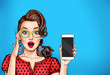 Attractive sexy girl in specs with phone in the hand in comic style. Pop art woman holding smartphone. Digital advertisement female model showing the message or new app on cellphone. 