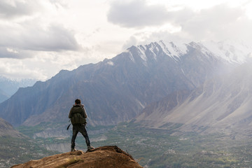 Wall Mural - traveller with backpack standing on mountain peak. summer outdoor travel activity trekking, hiking