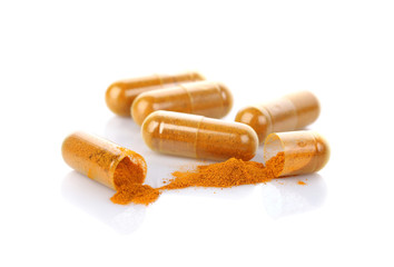 Wall Mural - Turmeric capsules isolated on white.