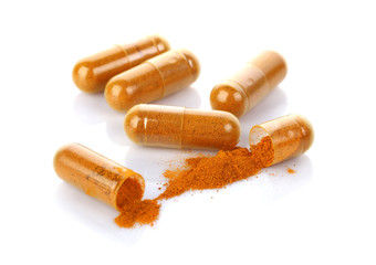 Wall Mural - Turmeric capsules isolated on white.