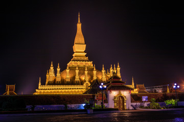 Wall Mural - Pha That Luang a gold buddhist stupa in the night, landmark of Vientiane, Laos PDR.