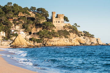 Wall Mural - Landscape of Lloret de Mar Castle and its beach in a sunny afternoon, Spain.