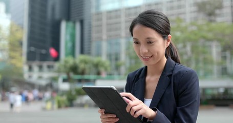 Poster - Business woman use of tablet computer at outdoor city