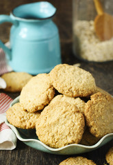 Wall Mural - Homemade oatmeal cookies on wooden table.