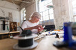 © pikselstock - Senior woman in electronics workshop
