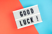 Good Luck -  Text On A Display Lightbox On Blue And Red Bright Background.